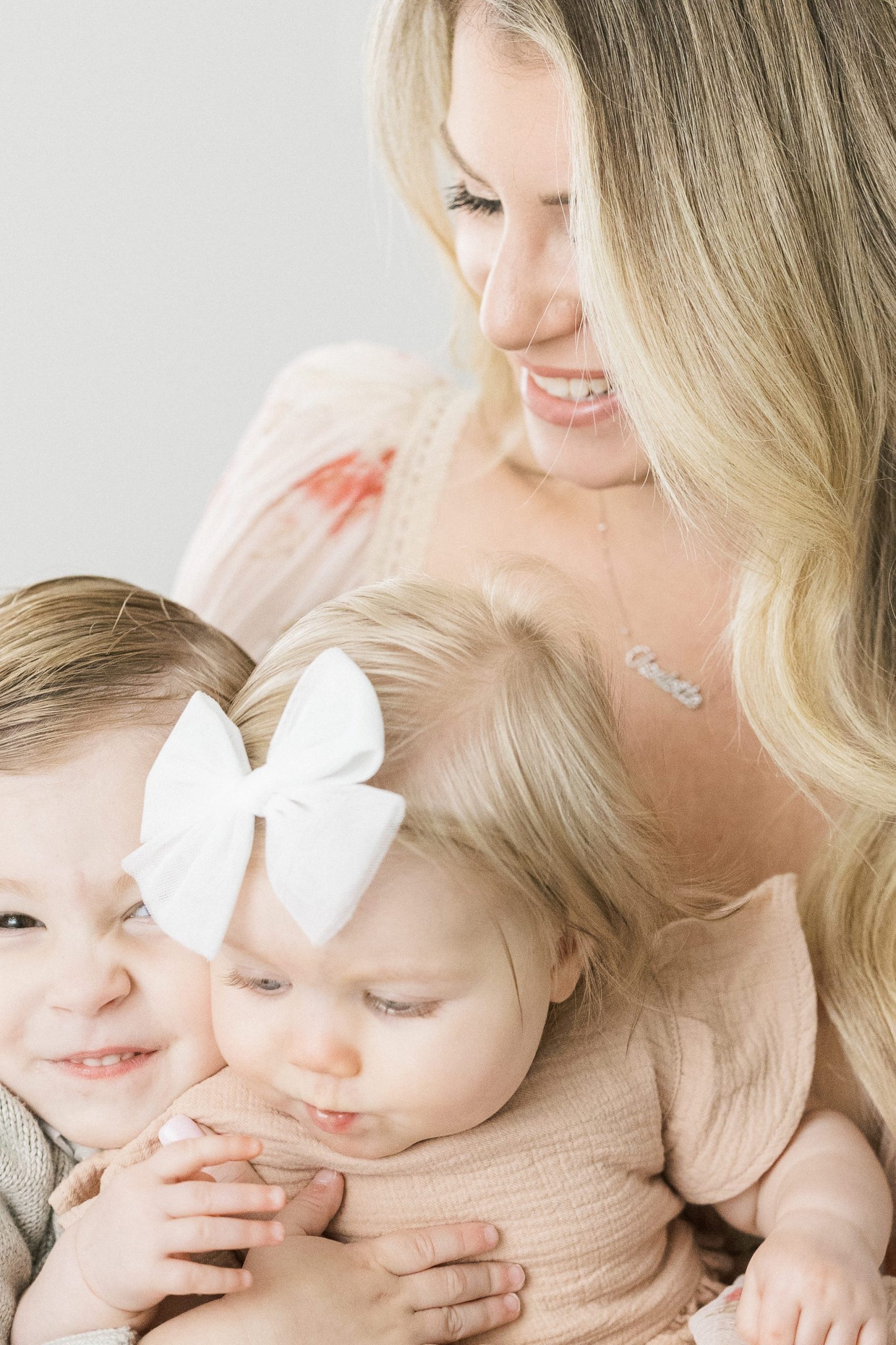 mom snuggling her babies on her lap by Philadelphia baby photographer