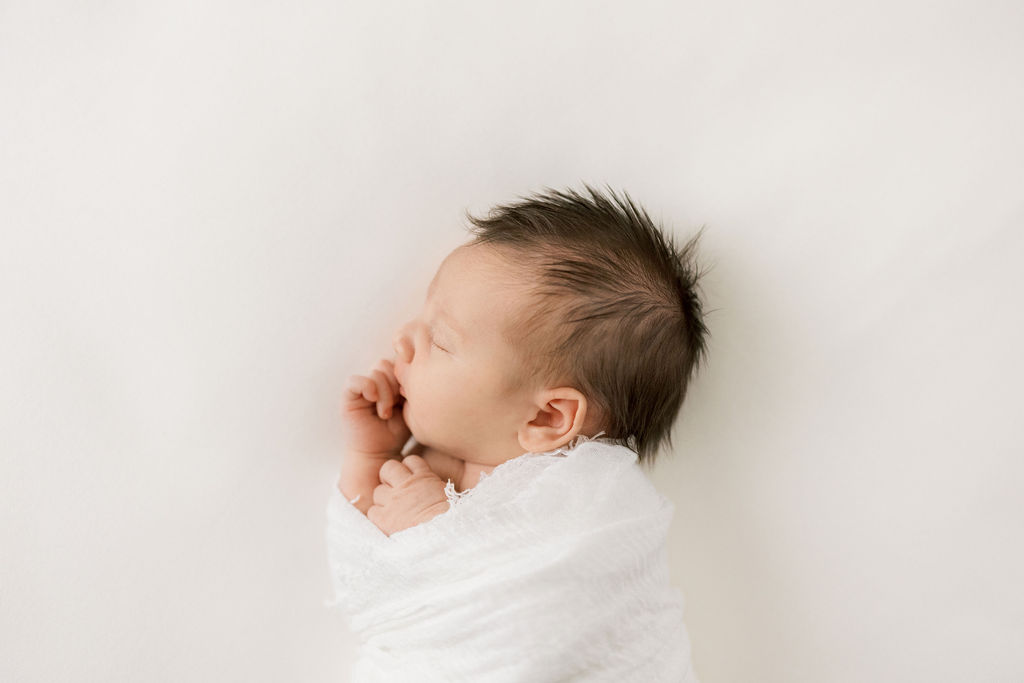 newborn baby in a white cloth