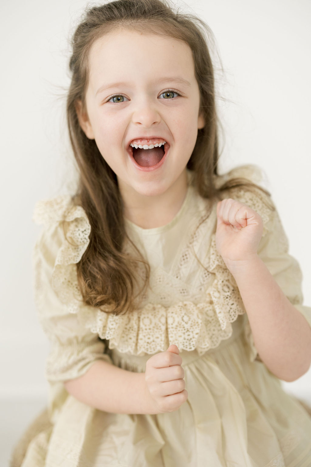 Girl in a beige lace dress dances in a studio Carriage Boutique