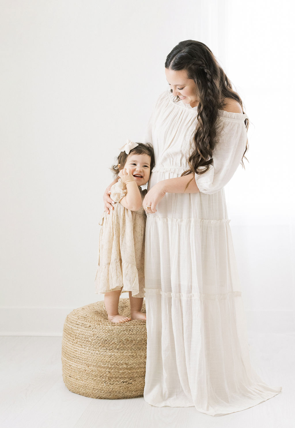 Mother and daughter stand together and play in a studio atlantic maternal fetal medicine